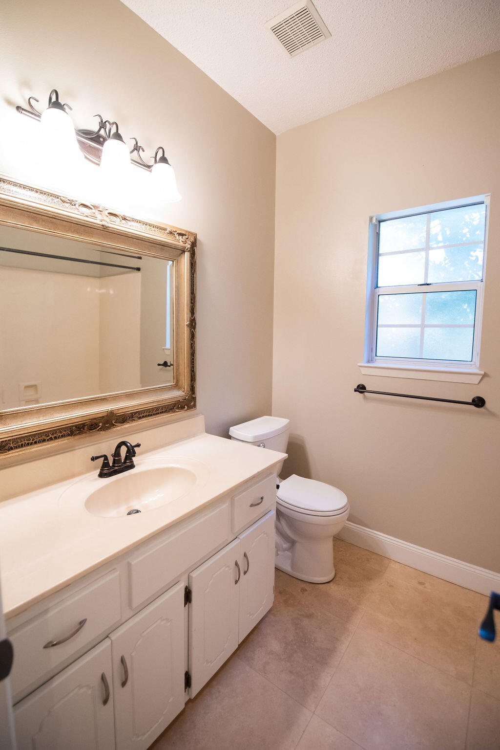 4565 Parkwood Court Niceville, FL 32578 - Photo 37 of 48 a bathroom with a toilet sink and mirror