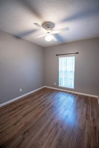 wooden floor in an empty room with a large window