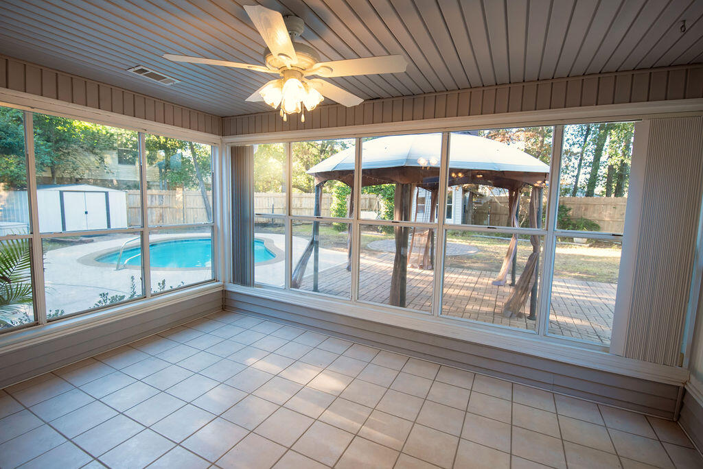 4565 Parkwood Court Niceville, FL 32578 - Photo 39 of 48 wooden floor in an empty room with a large window