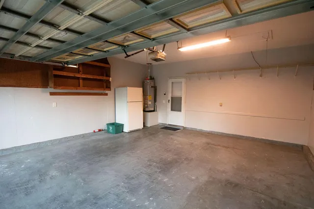 a front view of a house with a yard chairs and iron fence