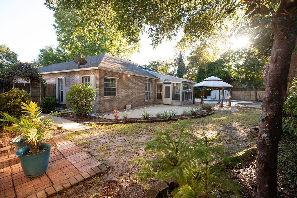 4565 Parkwood Court Niceville, FL 32578 - Photo 43 of 48 a front view of a house with a yard chairs and iron fence