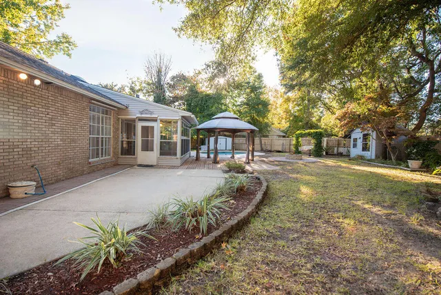 a view of a backyard with a patio and plants