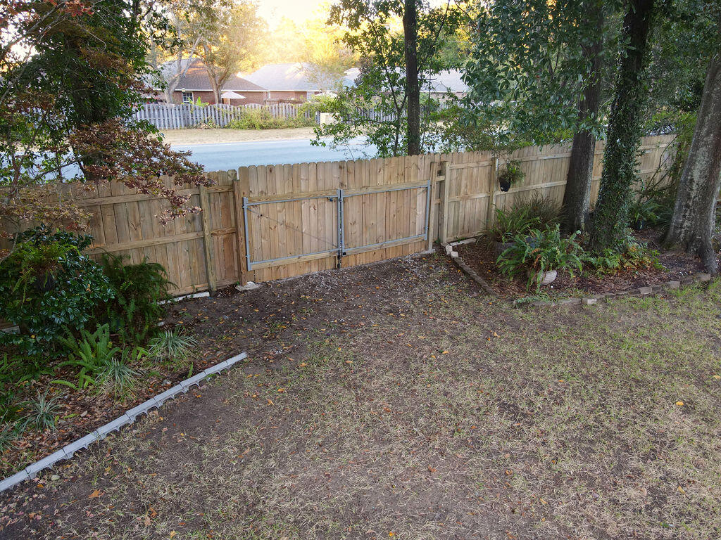 4565 Parkwood Court Niceville, FL 32578 - Photo 48 of 48 a view of backyard with green space and wooden fence