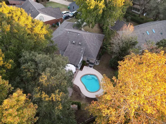an aerial view of a house with yard swimming pool and outdoor seating