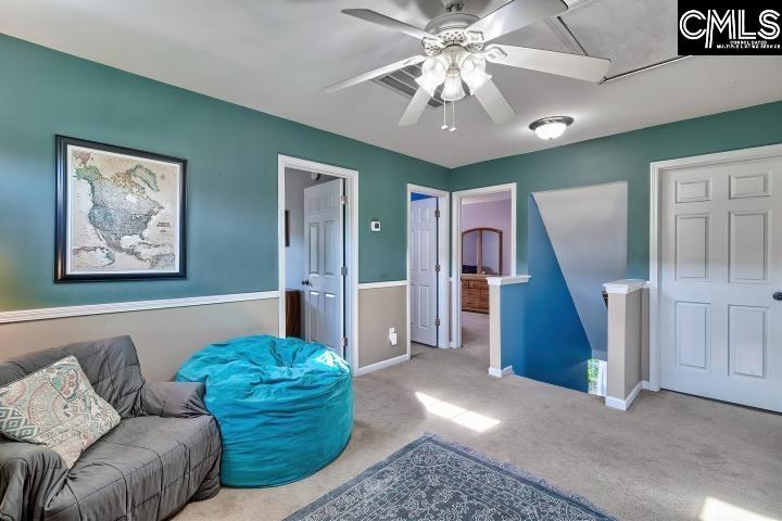 209 Eagle Pointe Drive Chapin, SC 29036 - Photo 22 of 40 a living room with furniture and a chandelier