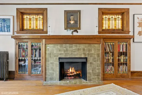 a living room with fireplace and a fireplace
