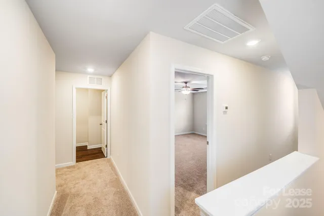 a view of hallway with bathroom