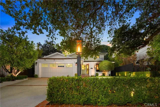 a front view of a house with a garden