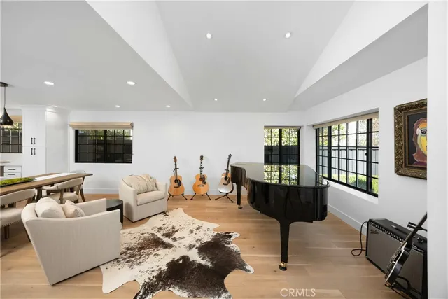a view of a dining room with furniture wooden floor and a floor to ceiling window