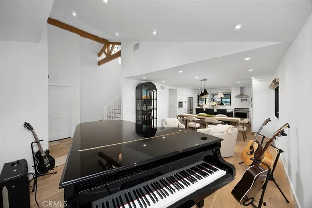 a kitchen with stainless steel appliances a white table chairs and a refrigerator