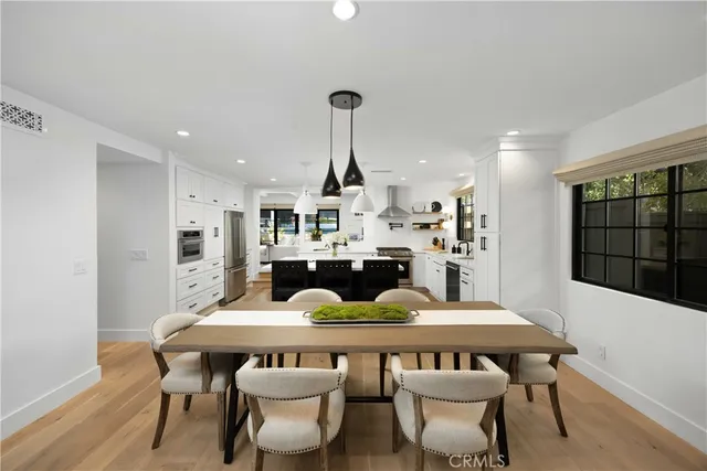 a kitchen with stainless steel appliances a sink stove and window