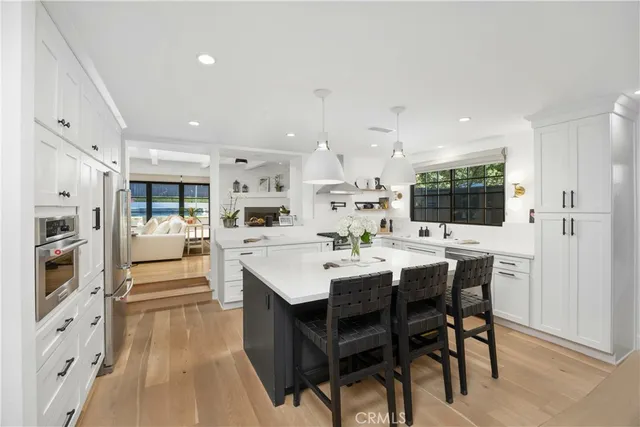 a living room with furniture fireplace and a large window