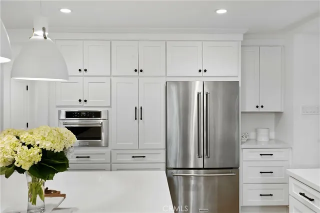 a bathroom with a sink a mirror a glass door and shower