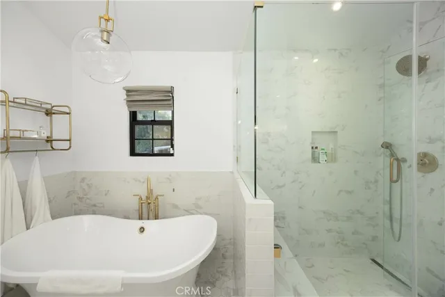 a view of a patio with table and chairs potted plants and large tree