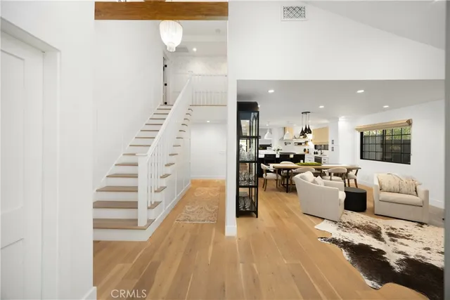 a living room with furniture large window and flat screen tv