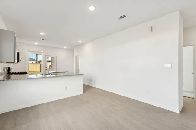 a view of kitchen with stainless steel appliances cabinets