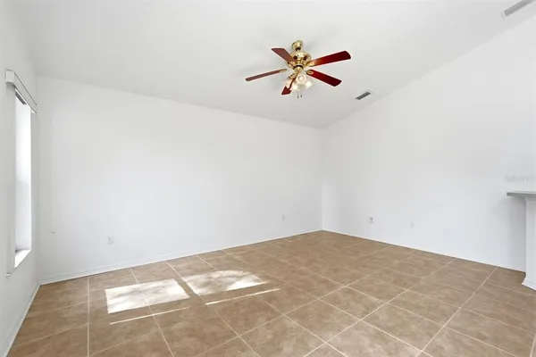 an empty room with closet and fan