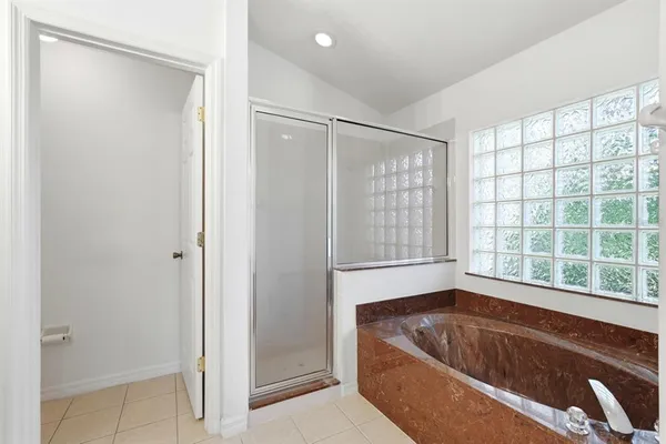 a bath tub sitting in a bathroom next to a window