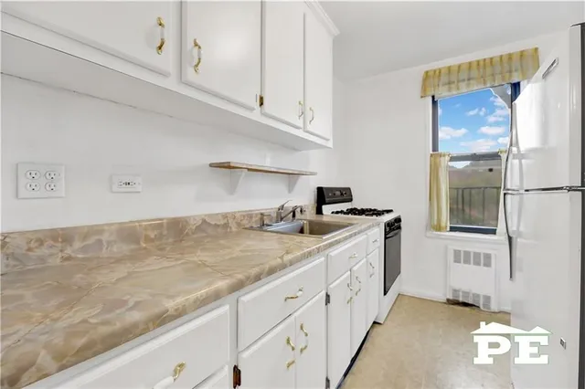 a kitchen with cabinets and a sink