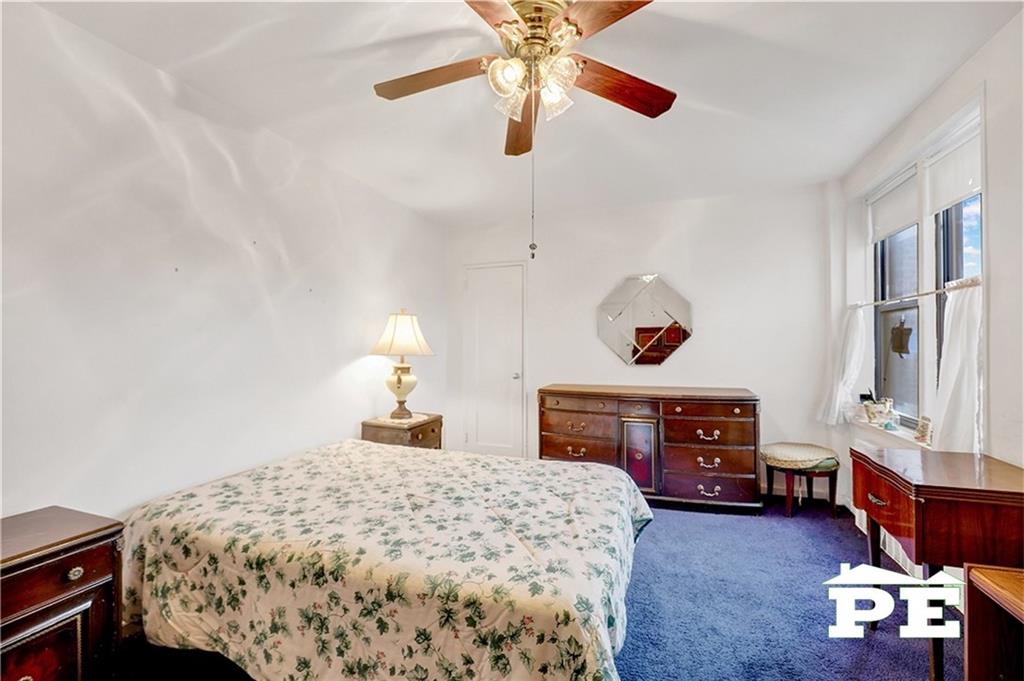 2425 Haring Street, Unit 4G Brooklyn, NY 11235 - Photo 21 of 29 a bedroom with a bed and a chandelier