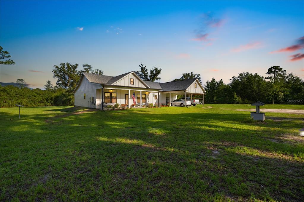 5149 Southwest 119th Road Lake Butler, FL 32054 - Photo 1 of 40 a front view of a house with garden
