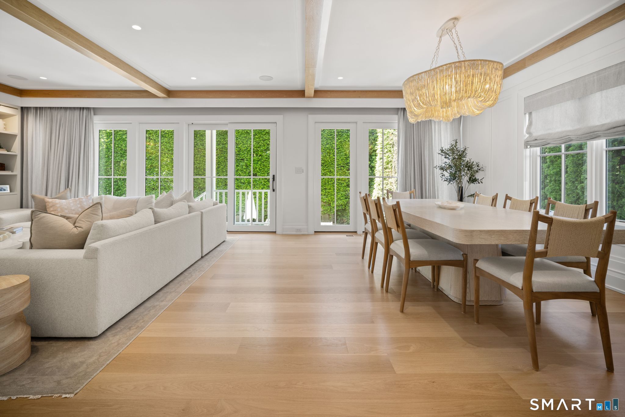 69 Birch Road Fairfield, CT 06824 - Photo 4 of 40 a view of a dining room with furniture large windows and wooden floor