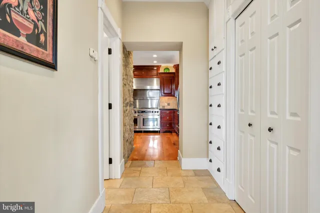 a kitchen with stainless steel appliances granite countertop a refrigerator a stove and a sink