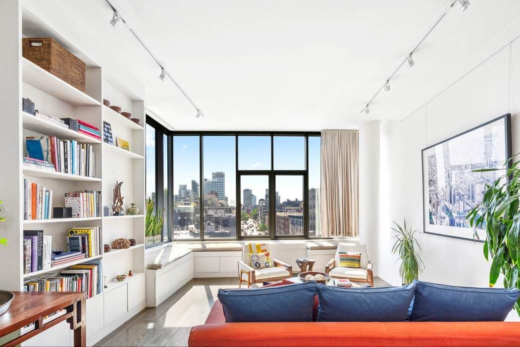 210 Lafayette Street, Unit 7A Manhattan, NY 10012 - Photo 1 of 13 a living room with furniture and a large window