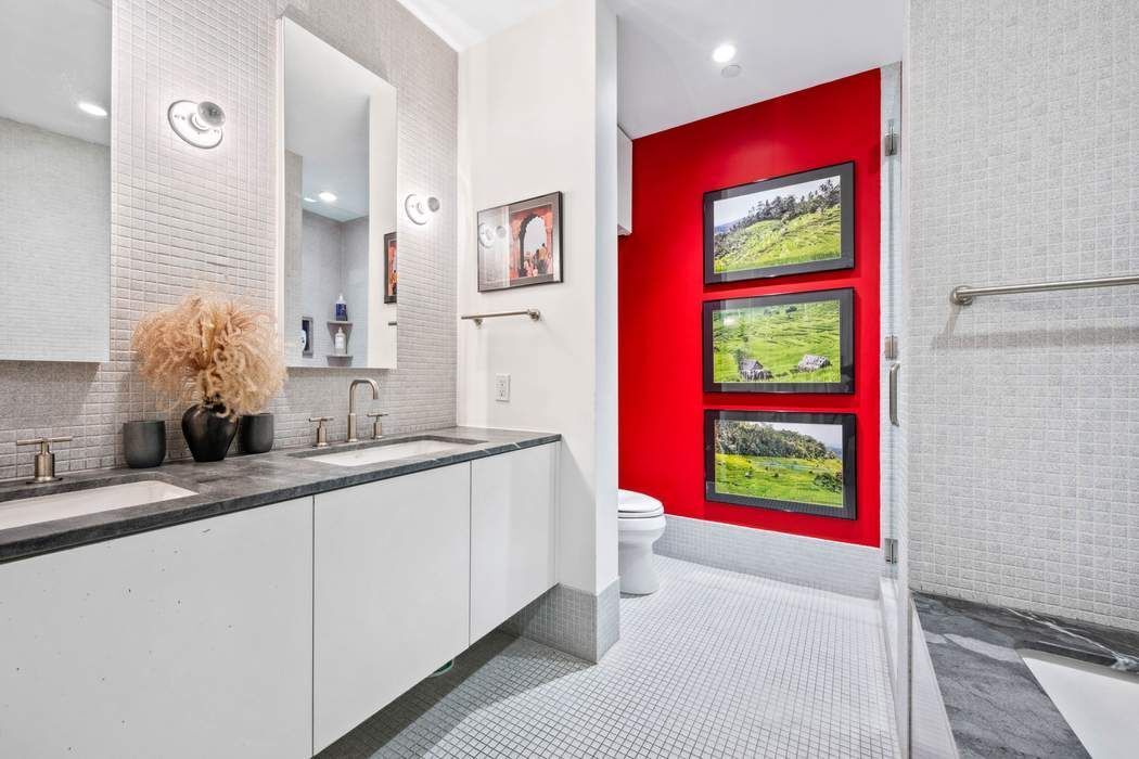 210 Lafayette Street, Unit 7A Manhattan, NY 10012 - Photo 9 of 13 a bathroom with a sink and a large mirror