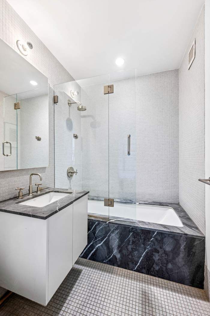210 Lafayette Street, Unit 7A Manhattan, NY 10012 - Photo 10 of 13 a bathroom with a sink and a mirror