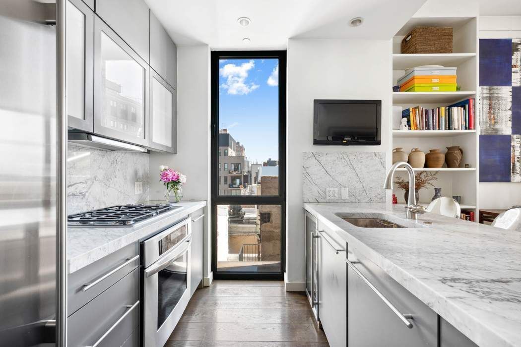 210 Lafayette Street, Unit 7A Manhattan, NY 10012 - Photo 4 of 13 a kitchen that has a sink and a stove