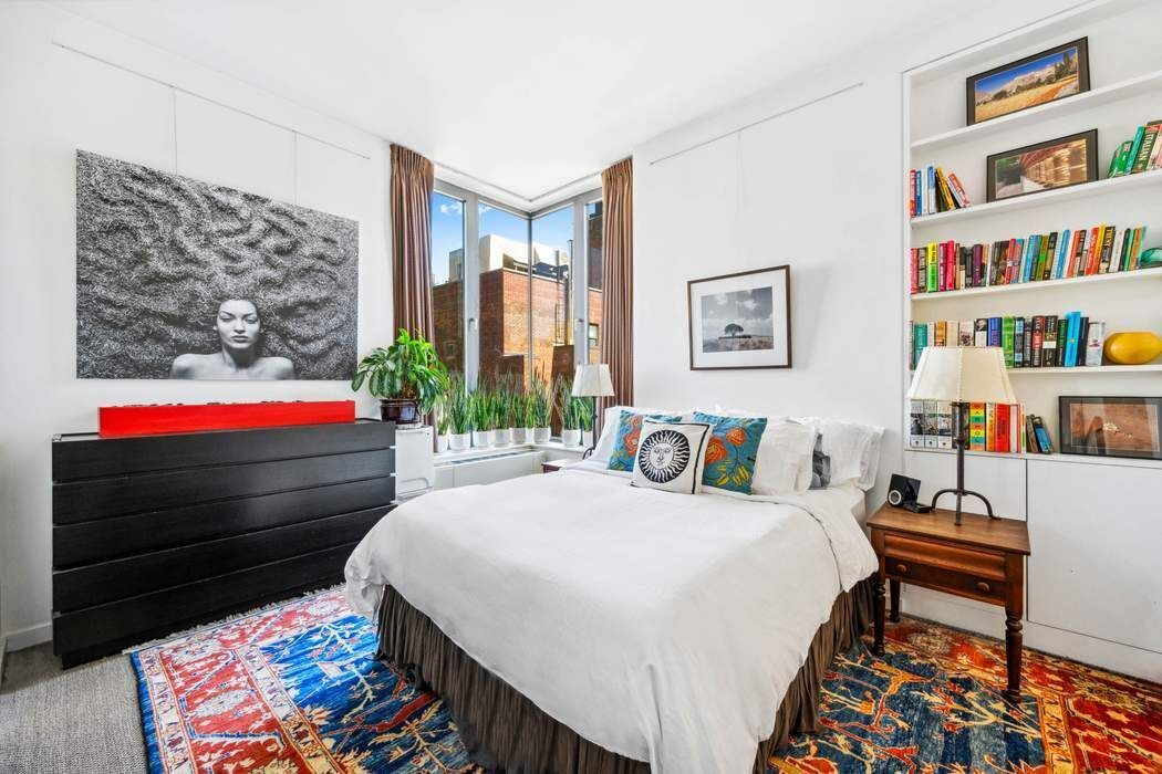 210 Lafayette Street, Unit 7A Manhattan, NY 10012 - Photo 7 of 13 a bedroom with a bed and a bookshelf
