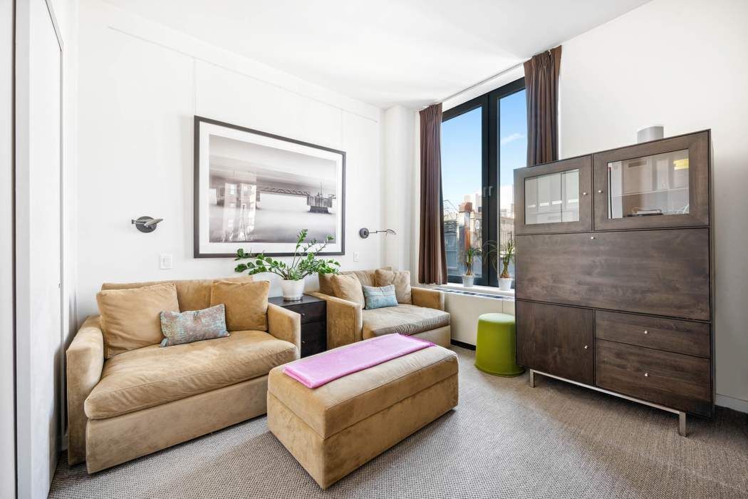 210 Lafayette Street, Unit 7A Manhattan, NY 10012 - Photo 8 of 13 a living room with furniture and a window
