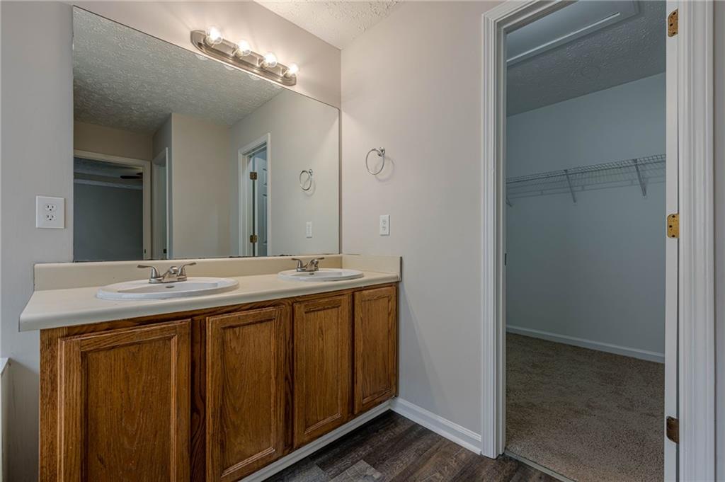1276 To Lani Farm Road Stone Mountain, GA 30083 - Photo 11 of 16 a bathroom with a granite countertop sink and a mirror
