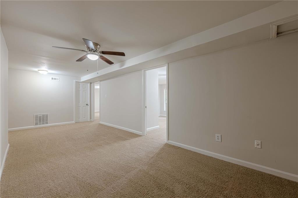 1276 To Lani Farm Road Stone Mountain, GA 30083 - Photo 12 of 16 a view of an empty room with a fan