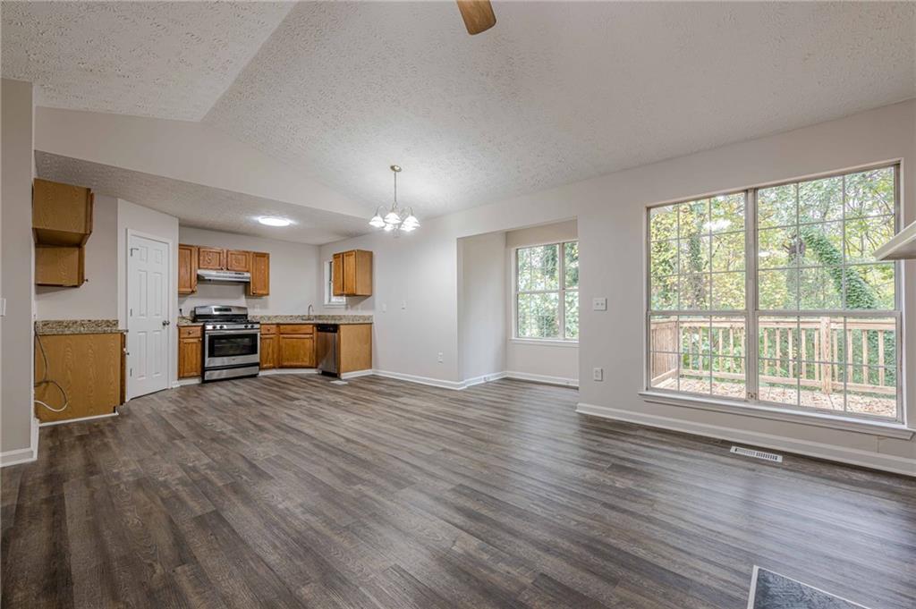 1276 To Lani Farm Road Stone Mountain, GA 30083 - Photo 5 of 16 a view of a kitchen with a sink wooden cabinets and a window