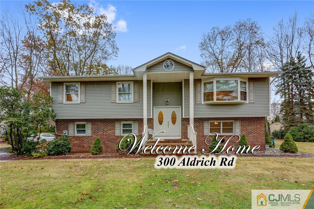300 Aldrich Road Howell, NJ 07731 - Photo 1 of 19 a front view of a house with a yard