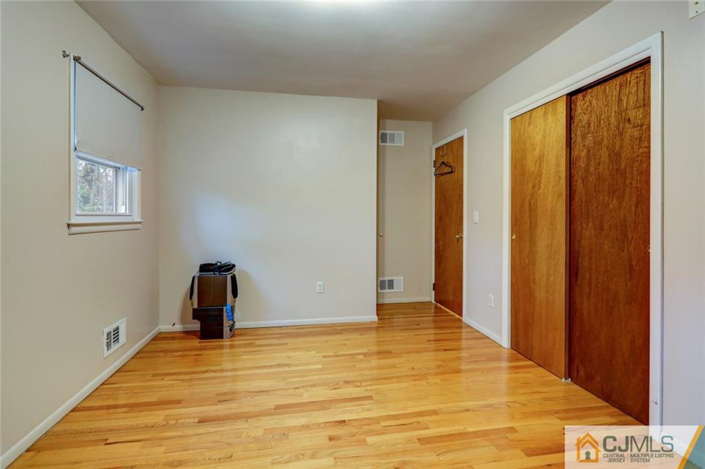 300 Aldrich Road Howell, NJ 07731 - Photo 13 of 19 a view of empty room with wooden floor and fan