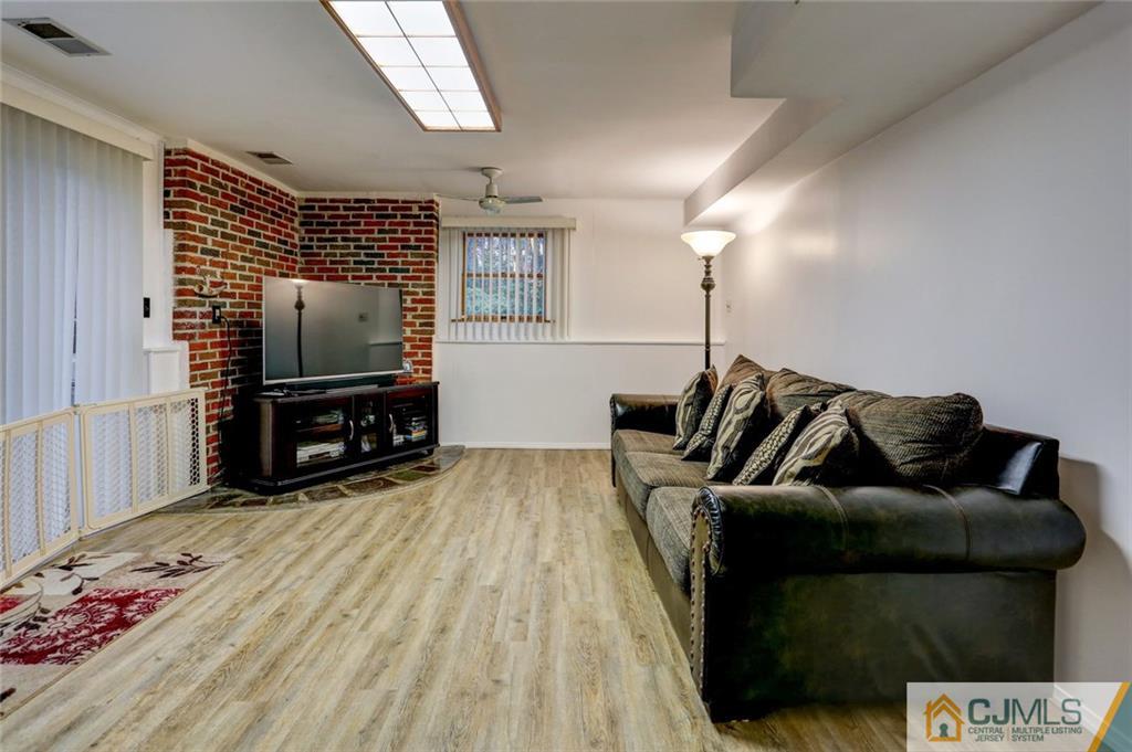 300 Aldrich Road Howell, NJ 07731 - Photo 14 of 19 a living room with furniture and a flat screen tv