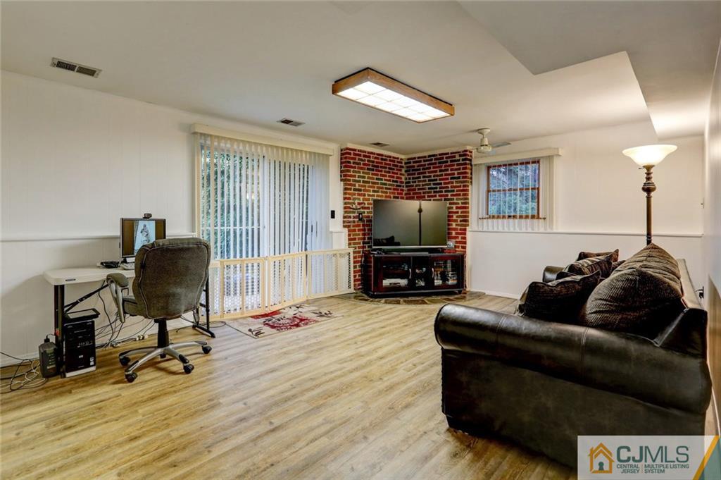 300 Aldrich Road Howell, NJ 07731 - Photo 15 of 19 a living room with furniture and a flat screen tv