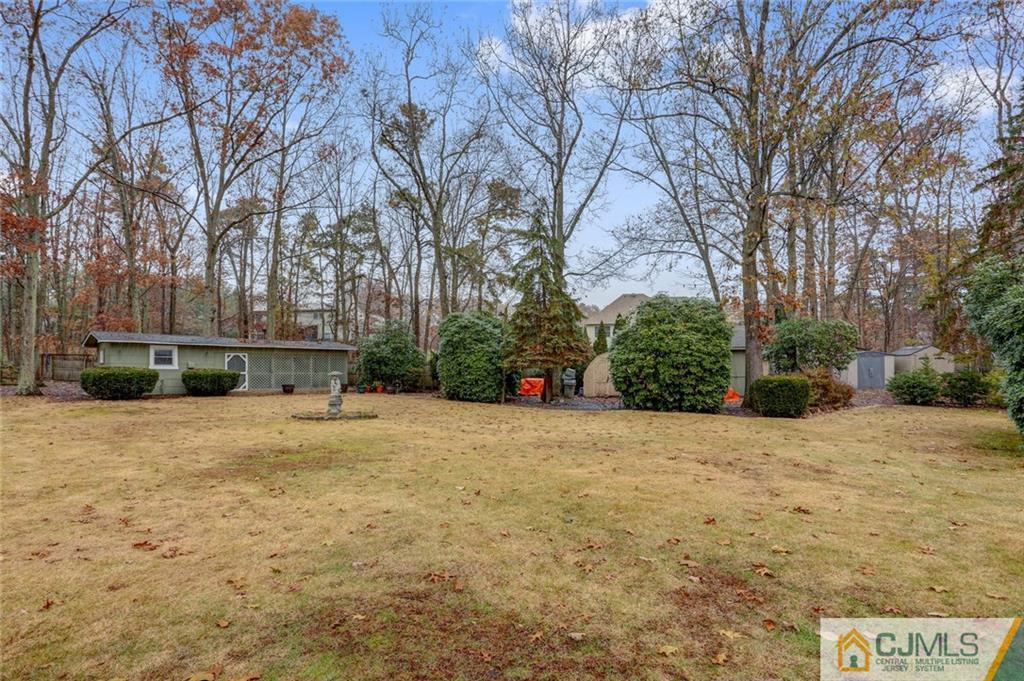 300 Aldrich Road Howell, NJ 07731 - Photo 19 of 19 a tall yellow house with trees in front of it