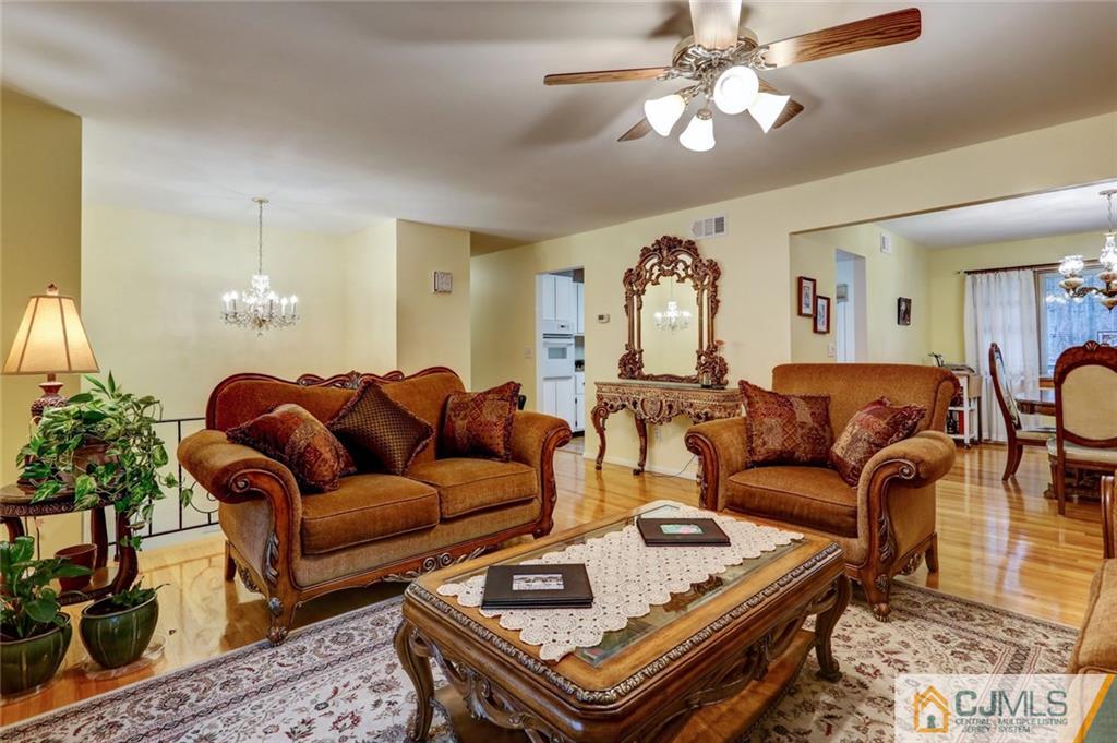 300 Aldrich Road Howell, NJ 07731 - Photo 4 of 19 a living room with furniture a chandelier and a rug