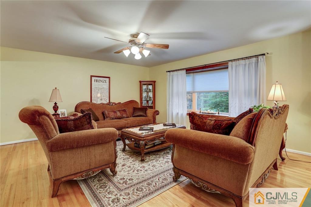 300 Aldrich Road Howell, NJ 07731 - Photo 5 of 19 a living room with furniture a chandelier and a window
