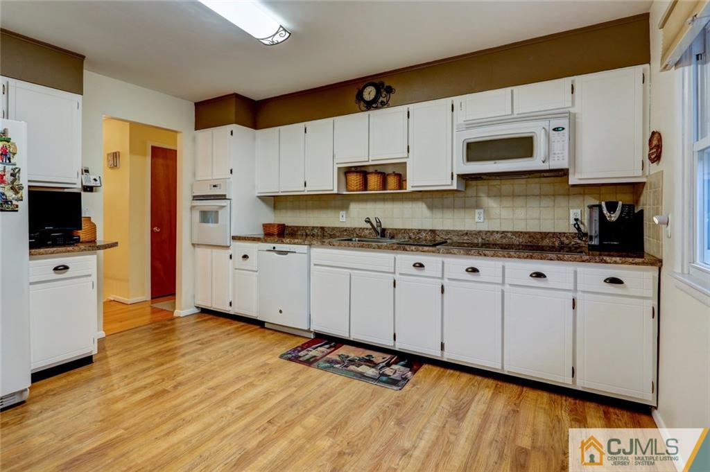 300 Aldrich Road Howell, NJ 07731 - Photo 8 of 19 a kitchen with stainless steel appliances granite countertop a stove a sink and a microwave