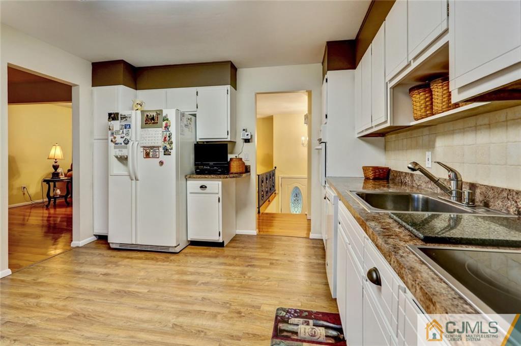 300 Aldrich Road Howell, NJ 07731 - Photo 9 of 19 a kitchen with stainless steel appliances granite countertop a refrigerator and a stove