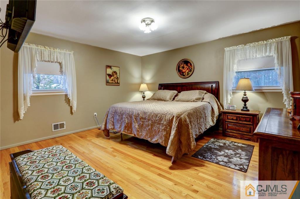 300 Aldrich Road Howell, NJ 07731 - Photo 10 of 19 a bedroom with a bed and a lamp on dresser