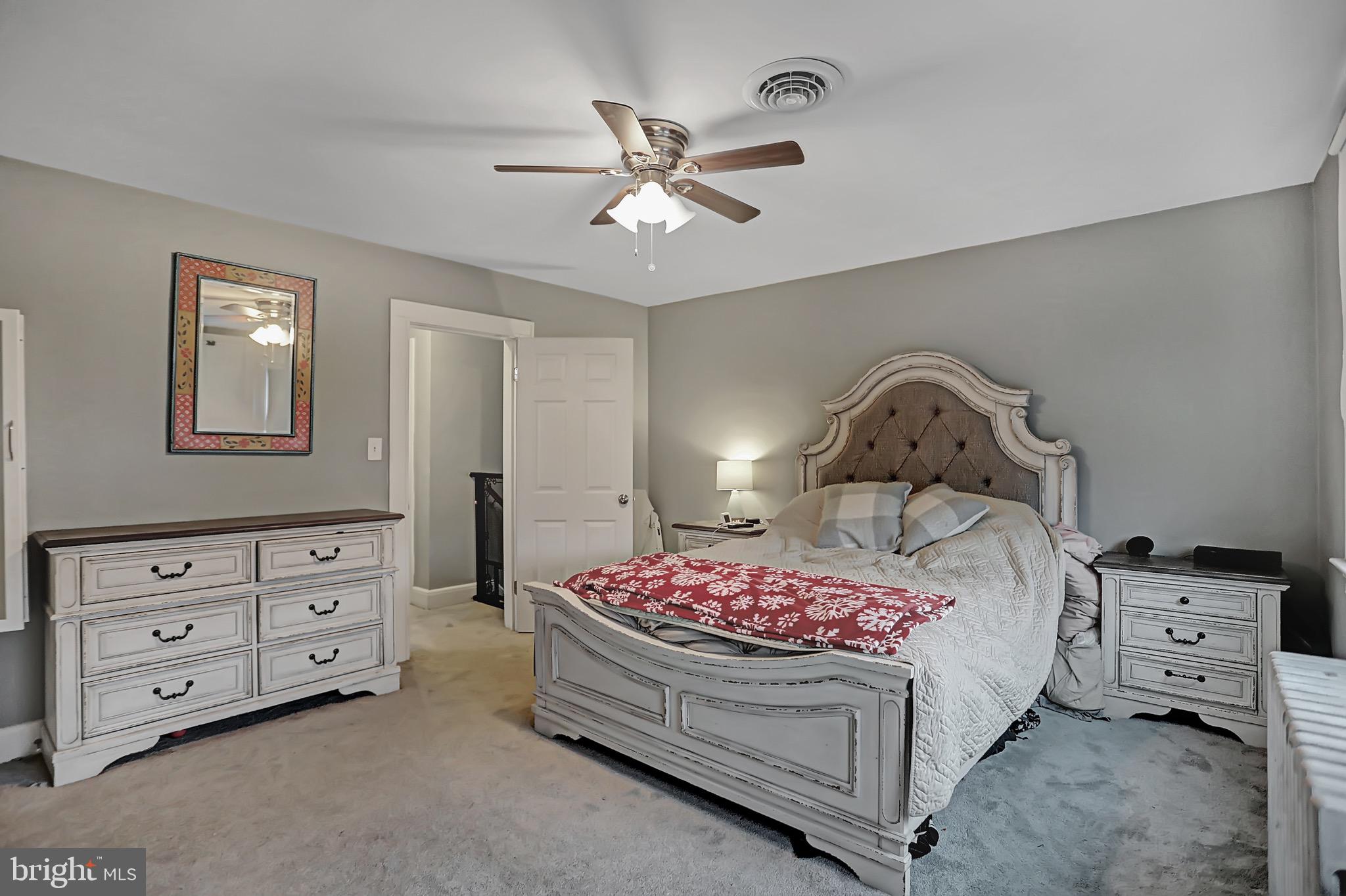 6811 Dunhill Road Baltimore, MD 21222 - Photo 22 of 36 a bedroom with a bed and a chandelier