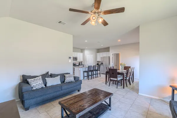 a living room with furniture a table and a chandelier