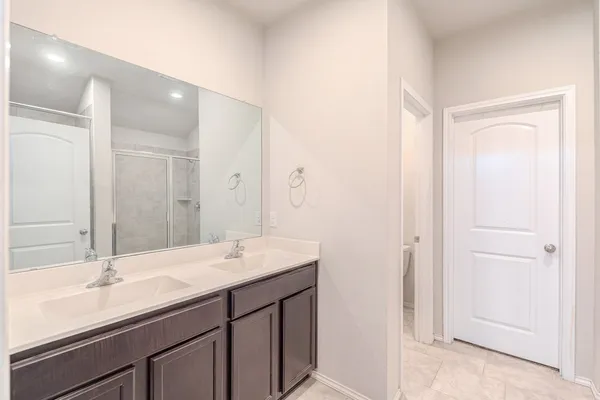 a bathroom with a sink double vanity and a mirror