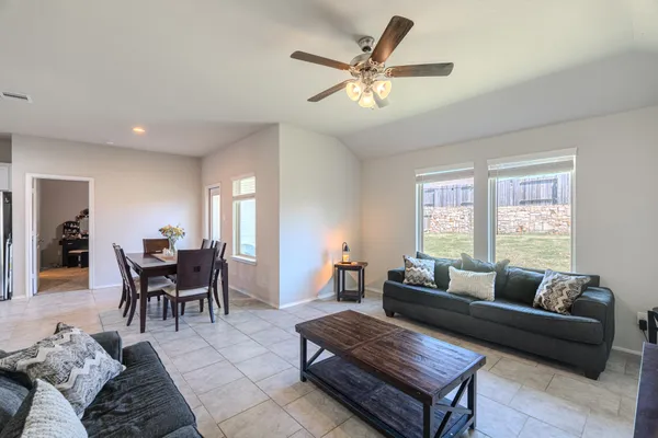 a living room with furniture a window and a dining table